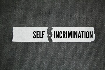 torn sticker with the word self-incrimination. the concept of self-blame. the concept of...