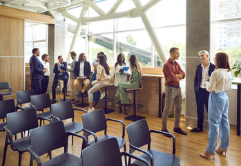 Diverse people meet and communicate at business networking event. Multiethnic male and female...