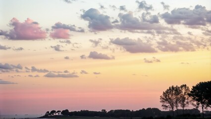 Colorful sunset with pink clouds over coastal landscape