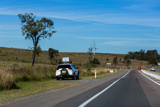 Your speed has been checked sign above police car at the side of highway road out of Singleton