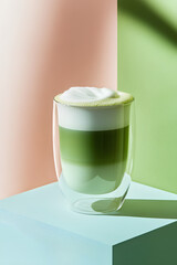 Indulge in a beautifully layered matcha latte served in a stunning glass, showcasing vibrant green hues. Enjoy this refreshing, non-alcoholic drink anytime