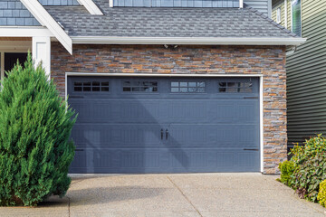 House with Garage door with windows. Garage door in luxury house. Metal garage door