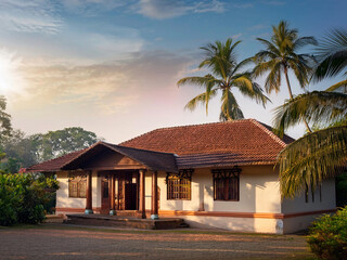 Elegant Kerala-style villa surrounded by lush greenery and serene landscapes. Showcasing traditional South Indian architecture with a harmonious connection to nature.