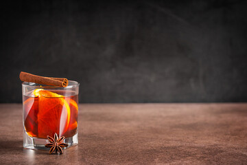 Hot traditional winter homemade mulled wine drink or punch with orange citrus fruit slices served...