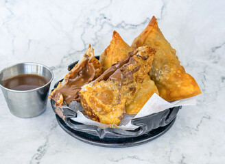 Chocolate Samosa with chutney served in tray isolated on grey background side view of Pakistani and Indian food