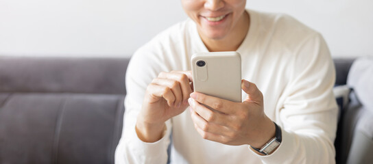 close up young asian man hold smartphone and check notification or read news or alert from...