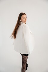 This photo shows a girl walking in a jacket and tights, turning into the frame