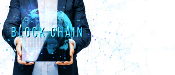 Businessman holding a tablet with a glowing digital globe and BLOCKCHAIN text, on white background, representing blockchain technology concept
