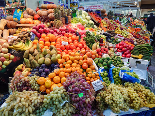 Various vegetables and fruits on the counter of the food market.