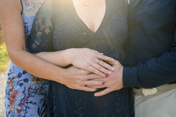 three hands on pregnant surrogates baby bump for expecting parents maternity