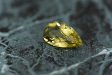 golden yellow citrine gemstone, on a black-white backgrond black-white marble