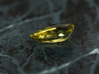 golden yellow citrine gemstone, on a black-white backgrond black-white marble