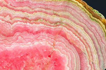 High-resolution image of rhodochrosite mineral specimen stone rock shows the intricate patterns and...