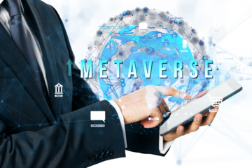 Businessman in a suit pointing at a tablet, digital globe overlay, futuristic blue-white background, concept of metaverse innovation