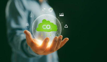 A Man hand showing globe with CO2 reducing icon with virtual and carbon credit to limit global...