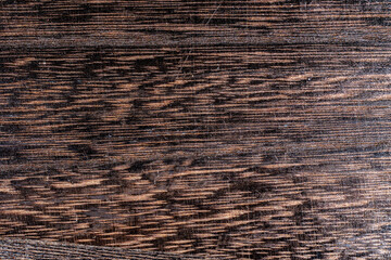 Dark brown black painted wooden desk background table texture table structure.