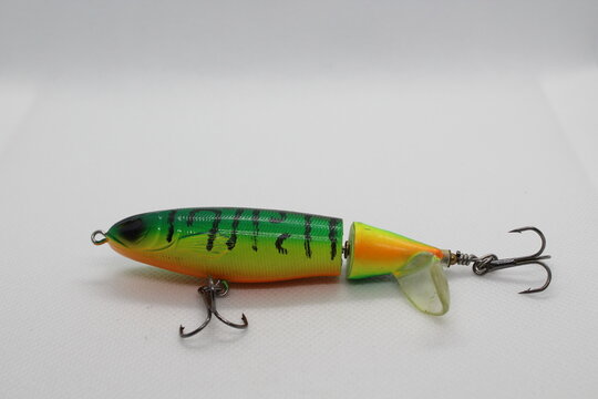 Green whopper plopper fishing lure isolated on a white background. Green wobbler popper flopper lure. Topwater fishing lure wobbler