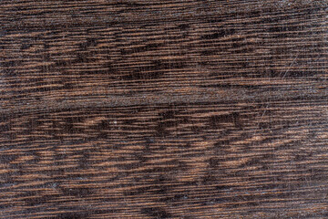 Fototapeta premium Dark brown black painted wooden desk background table texture table structure.