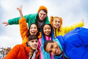 Multiracial group of young friends meeting outdoors in winter
