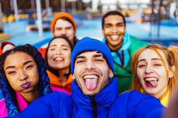 Multiracial group of young friends meeting outdoors in winter