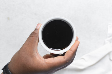 Overhead view of dark molasses in a white bowl, top view of blackstrap molasses