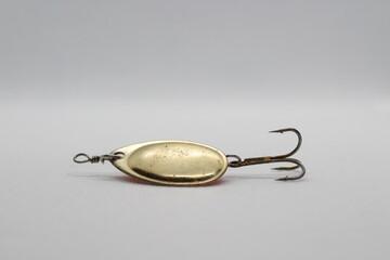 Golden spinnerbait for fishing isolated on a white background. Fishing lures on white background....