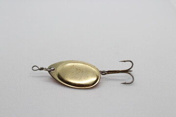 Golden spinnerbait for fishing isolated on a white background. Fishing lures on white background....