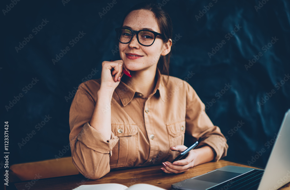 Aufkleber half length portrait of happy female graphic designer in eyeglasses smiling at camera while holding 