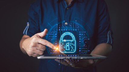 A person interacts with a glowing lock icon on a tablet, symbolizing secure cyber data protection,...