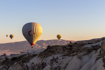 Hot air balloons take off at dawn in Cappadocia