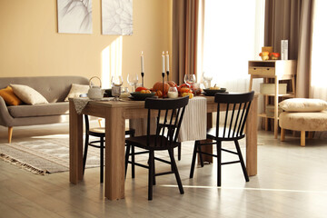 Fototapeta premium Stylish dining room with beautiful table setting and autumn decor