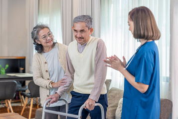 Fototapeta premium senior man using walker walking at home,a nurse caregiver and a wife take care and support beside him,concept for elderly health care,health insurance,home health nursing