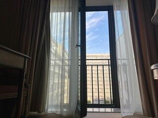 Fototapeta premium Hotel room with open balcony door, low angle view