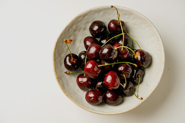 fresh cherries on the white background on a plate