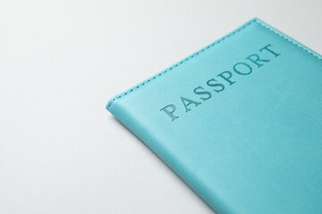 Passport in blue cover on light background, closeup. Space for text