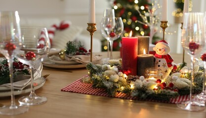 Christmas place setting with festive decor on wooden table in room