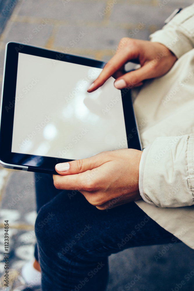 Poster cropped view of modern touch pad with mock up area for your advertising text message.female hands ho