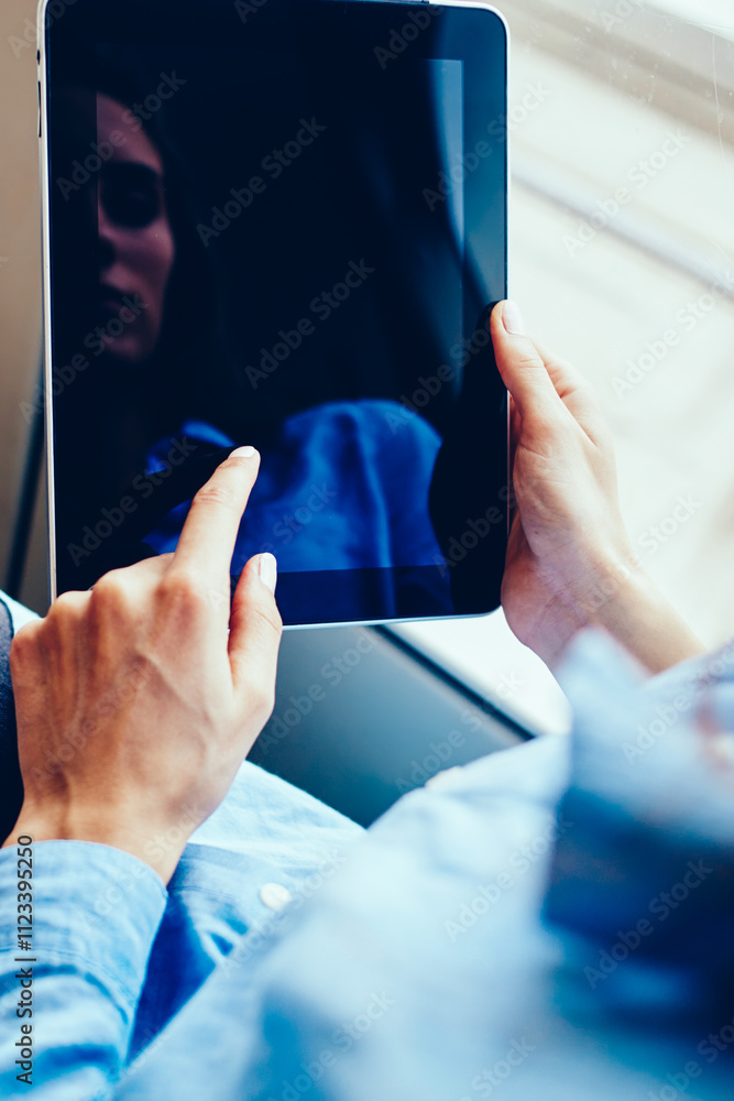 Aufkleber cropped view of hipster girl choosing application to install on modern touch pad device using public