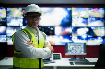 CCTV officer is monitoring traffic via multiple monitors in the control room.