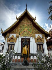 The ornate green, red, and gold facade of a small temple (Chiang Mai, Thailand)