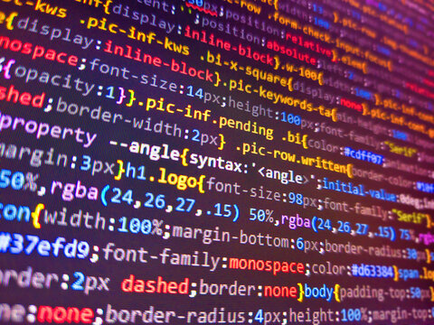 Fundamental and technical analysis concept. Developer screen with colored website programming code. Php code on blue background close up, pixels. Computer script. Computer html code on screen.