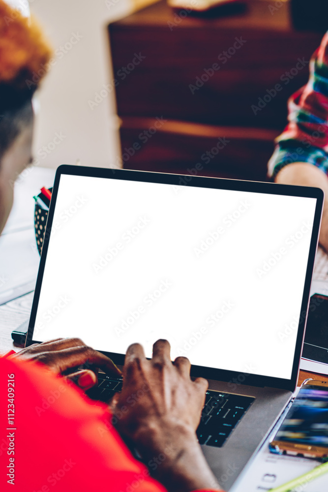 Aufkleber cropped back view of african american young man keyboarding text on modern laptop device with copy s