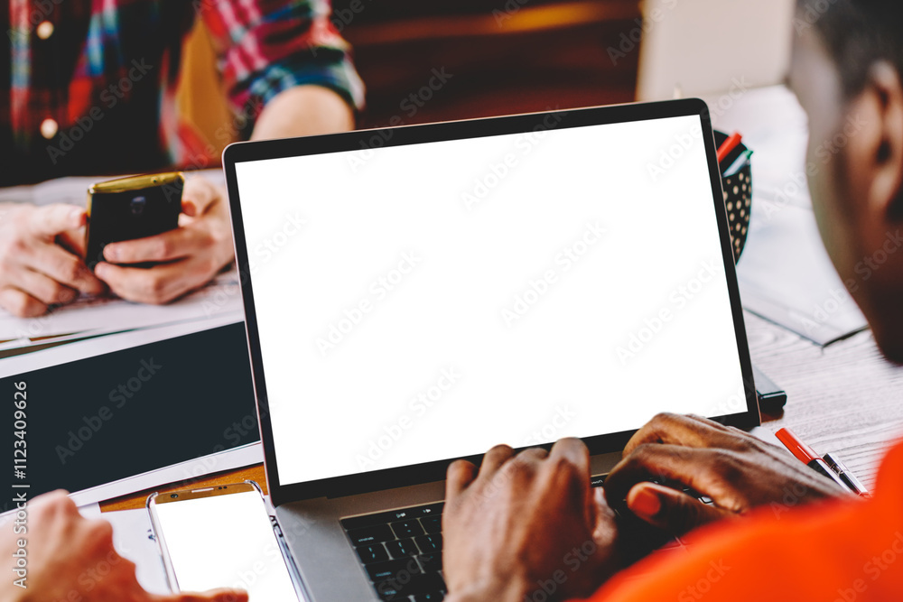Poster cropped back view of dark skinned blogger updating software on modern laptop device with copy space 