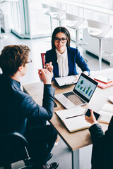 Two female colleagues have important meeting with male finance director of company discussing...