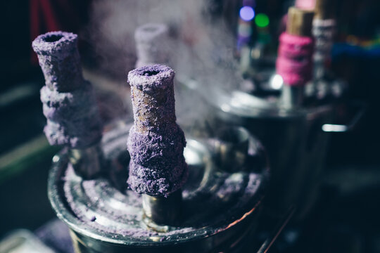 Cooking Puto bumbong, a popular Filipino delicacy of steamed purple rice cakes in sticky logs sold traditionally during Christmas season in night market. Selective focus.