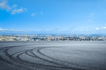 Empty asphalt road and cityscape with skyline in modern city
