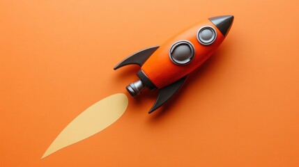 Orange Toy Rocket Launching On Orange Background