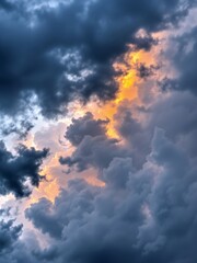 Dramatic Sunset Behind Dark Storm Clouds with Vibrant Orange Highlights