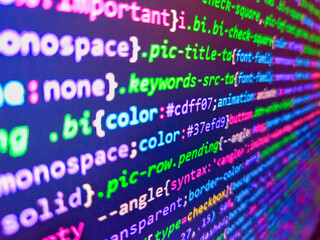 Assembly programming language code. Website codes on monitor. Business graph background. Application source code background. Coding concept. Closeup tablet screen technology background.