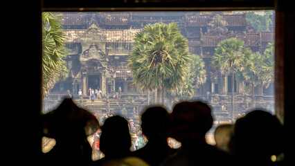 Cambodscha, Angkor wat statues and nature all around 
tourists admire the view 
tourist with a...